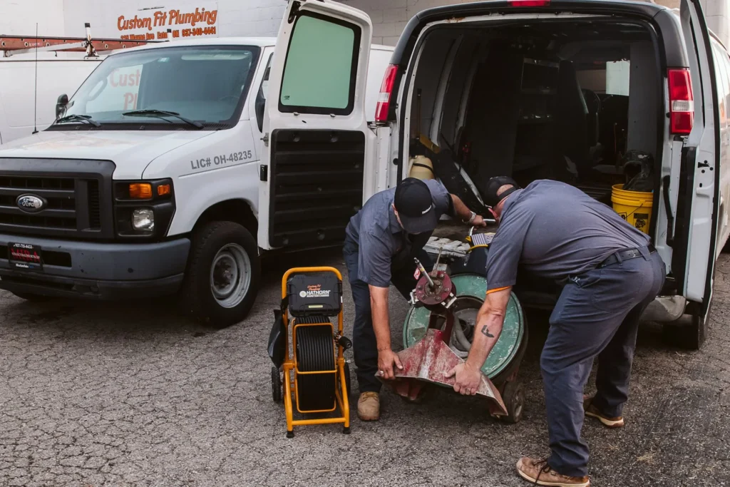 Licensed Custom Fit Plumbing technician servicing a residential drain and pipe system in Eaton, Ohio